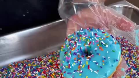 Glazed Donut with rainbow sprinkles. Do you want a bite From Friendly Donuts in Orange.