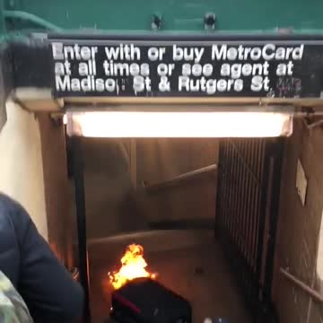 Black suitcase on fire bottom of subway stairs