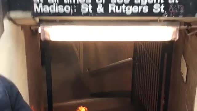 Black suitcase on fire bottom of subway stairs