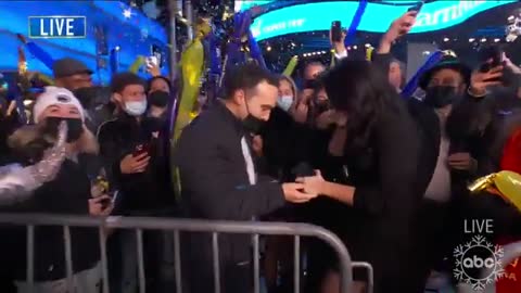 Couple gets engaged and then kisses with their masks on