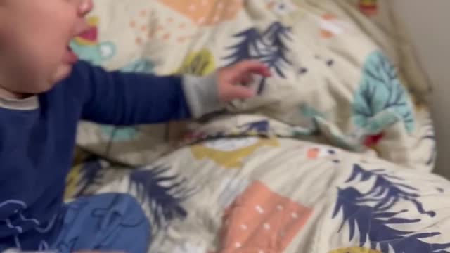 Baby cries over a toy he throws himself over and over