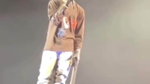 Travis Scott Sings while staring at someone possibly dying