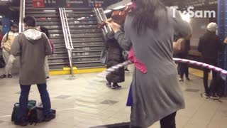 Woman plays violin and hula hoops