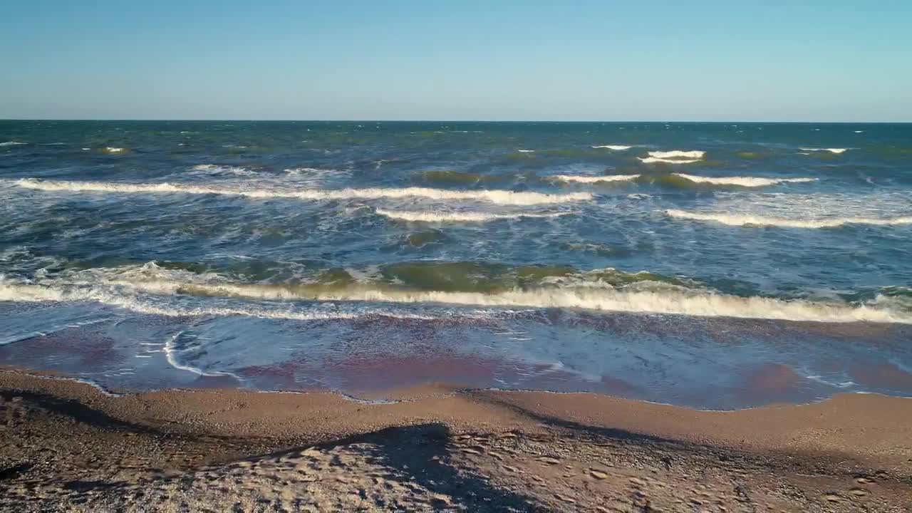 Sea waves reaching the sand on the beach