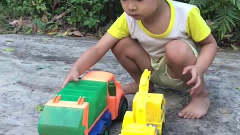 BABY PLAYING WITH TOY CAR