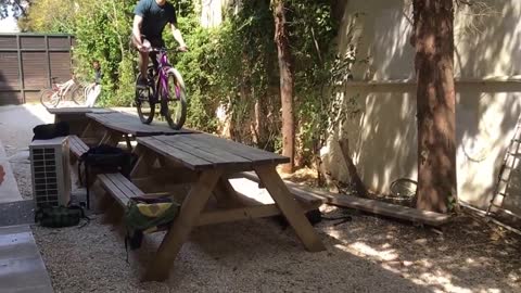 Purple bike picnic table front fail