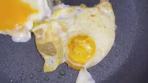 Simple routine, turning the fried egg upside down.