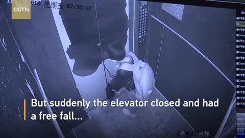 Boy uses umbrella to prevent elevator door from closing, causes free fall