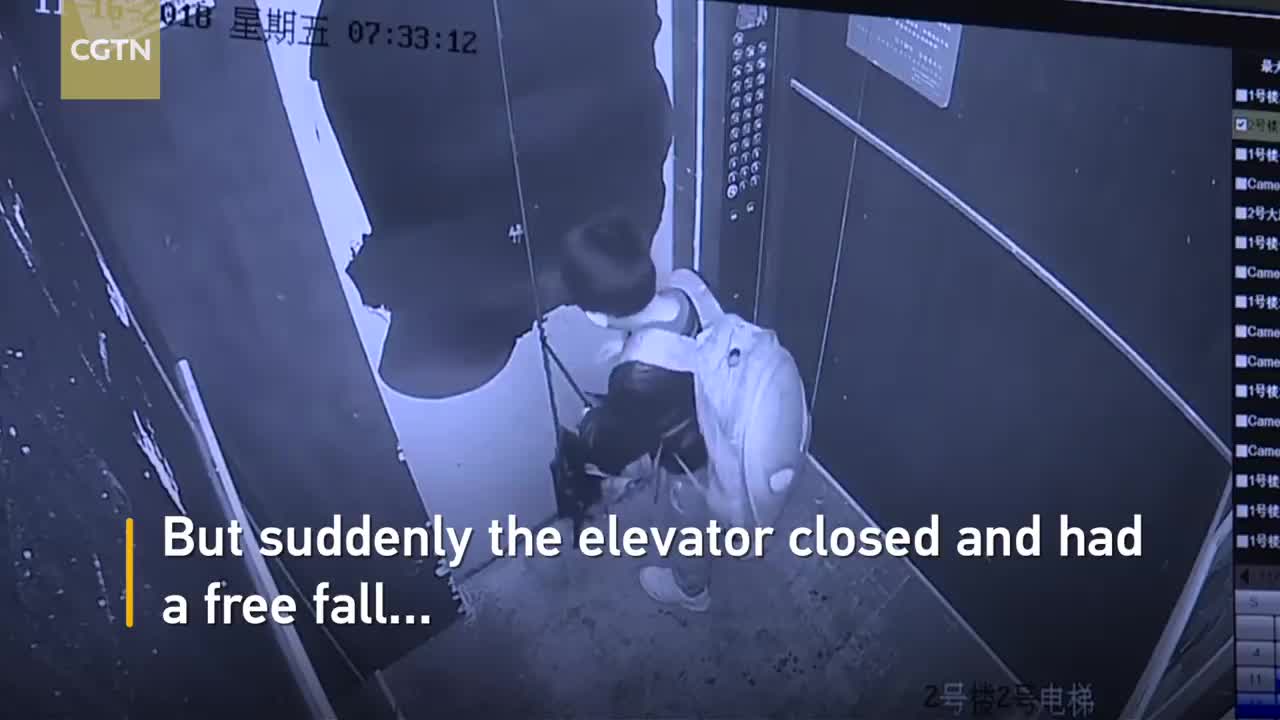 Boy uses umbrella to prevent elevator door from closing, causes free fall