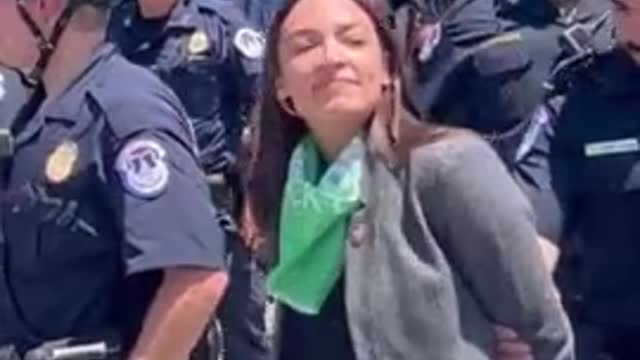 Why is AOC Pretending to be Handcuffed?