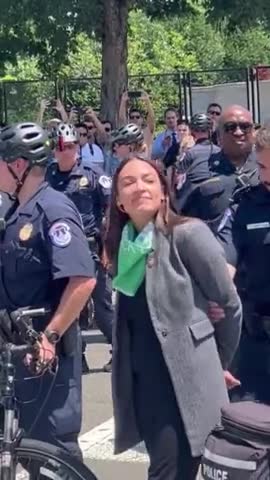 Why is AOC Pretending to be Handcuffed?