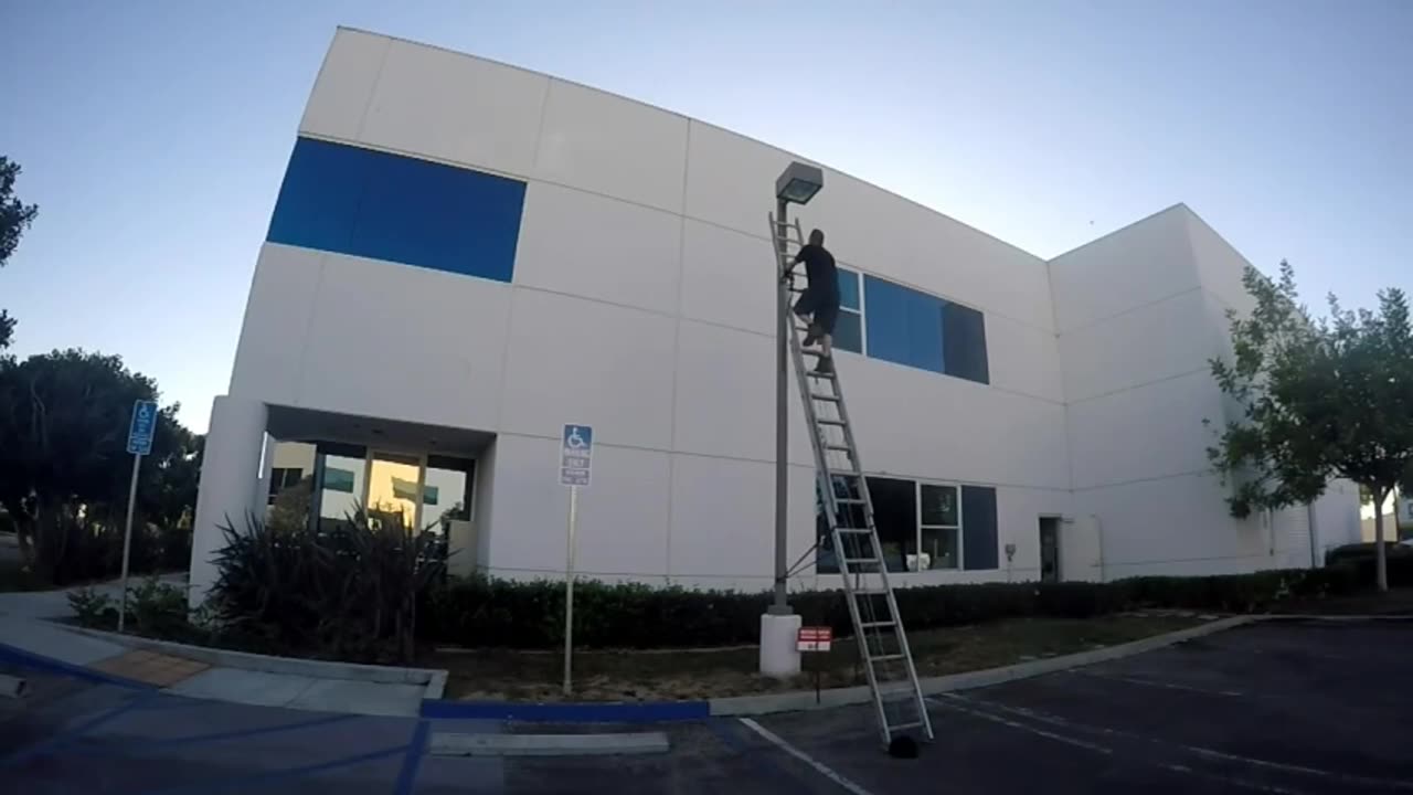 Guy_Accidentally_Breaks_Street_Light_Pole_and_Falls_While_Trying_to_Fix_it_Standing_on_Ladder