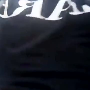 A thief steals a TV reporter's phone during live coverage on the road