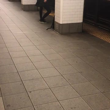Black skinny jeans grey shirt dancing subway station platform