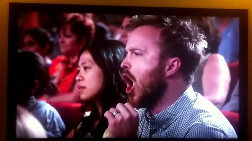 Bryan Cranston throws a pizza at Jimmy Fallon