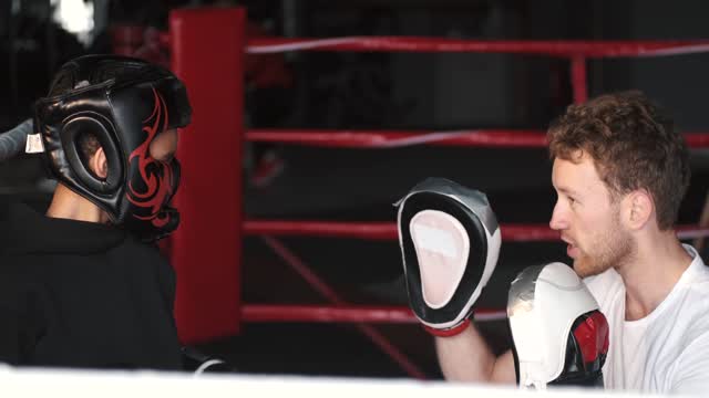 Man Teaching the Boy in the Boxing Ring