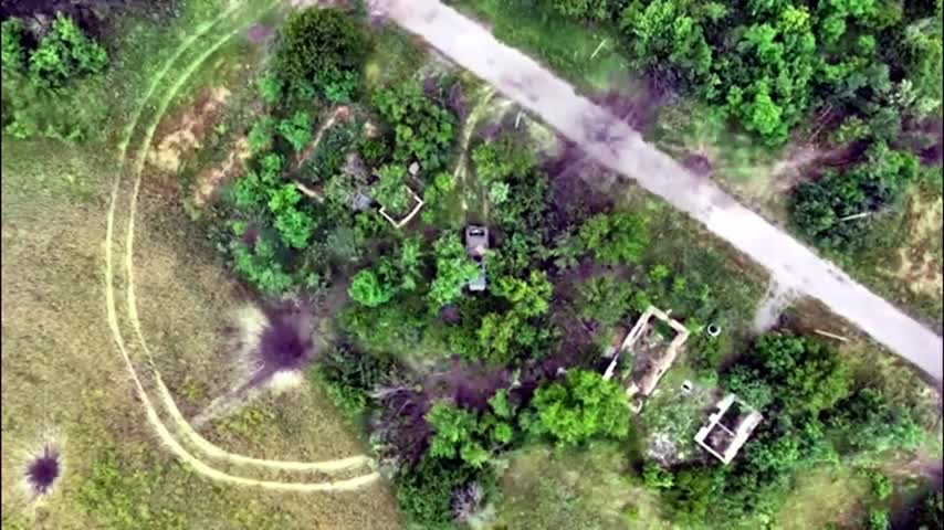 Ukrainian Forces using drone dropping munition on a Russian armoured fighting vehicle