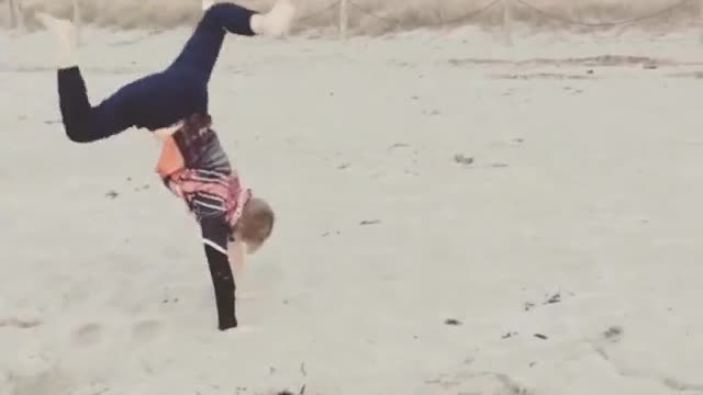 Orange shirt kid does handstand on stand and falls on blonde head