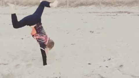 Orange shirt kid does handstand on stand and falls on blonde head