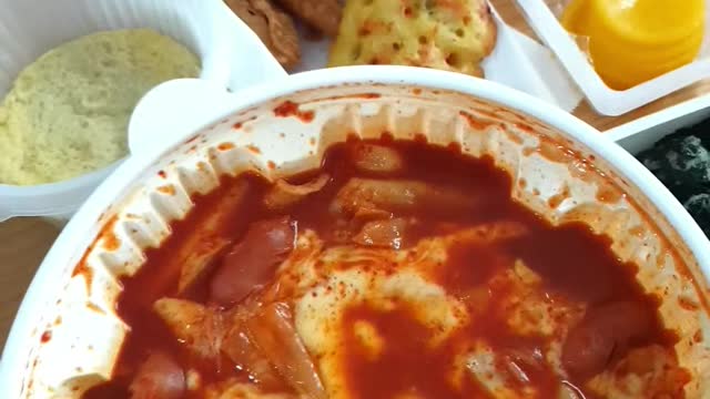 Korean mukbang tteokbokki, sundae, steamed eggs, and fried food.