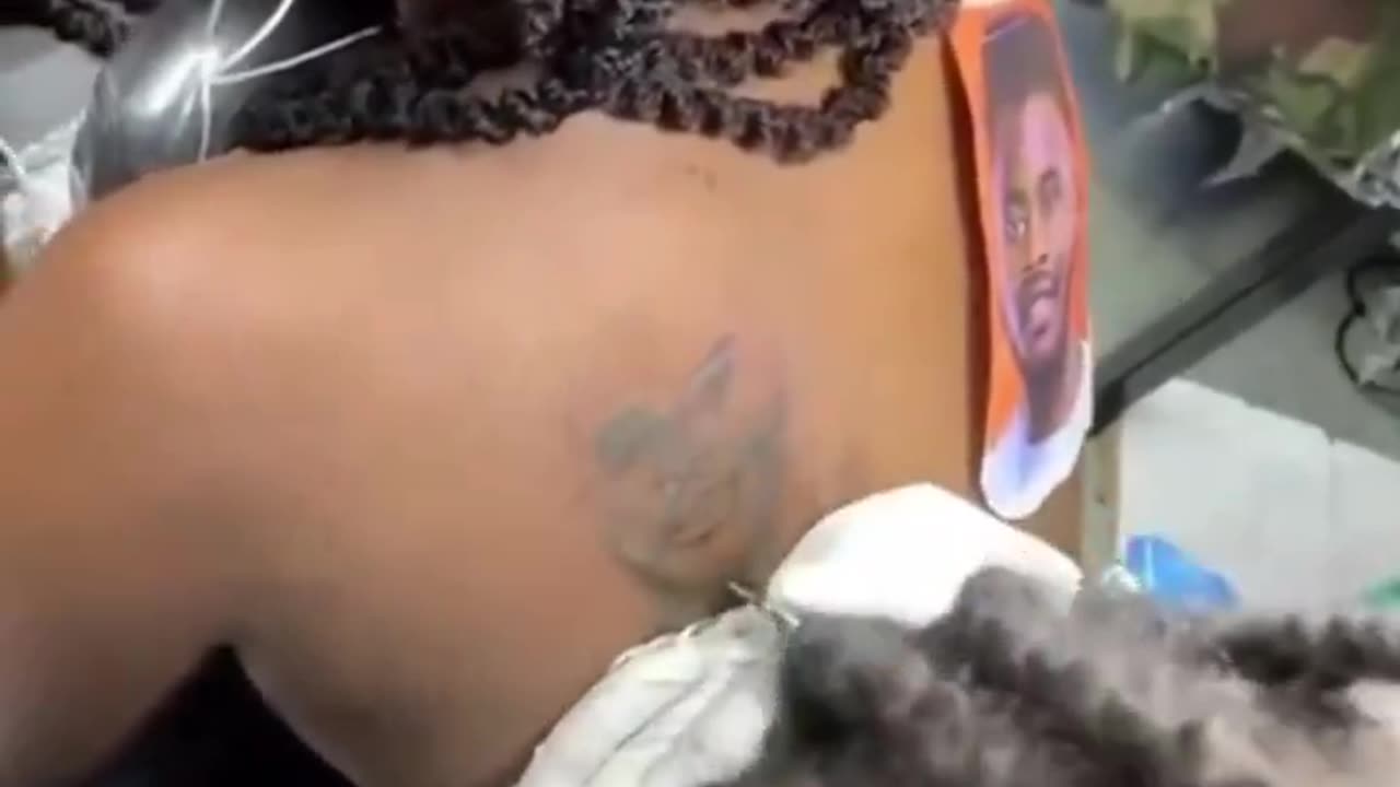 Nigerian lady shares a video of herself getting a tattoo of her Boyfriend’s face