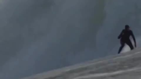 Surfer Rides a Giant Wave—Is It Brave or Just Crazy?! 🌊😱
