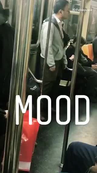 Guy in grey jacket dances and sways on subway