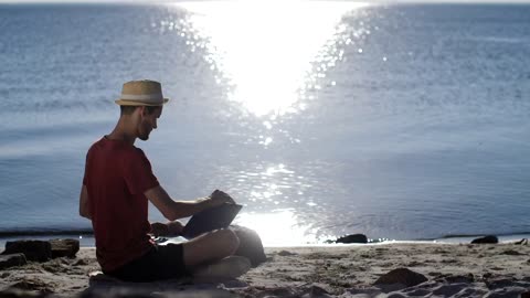Man working from the beach
