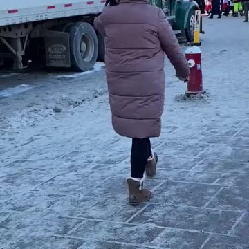 This masked woman was taking photos of trucks in Ottawa. Can anyone identify her?