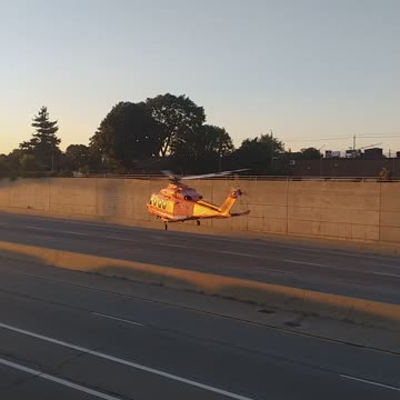 Helicopter landing in middle of the road.