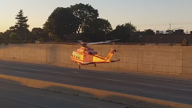 Helicopter landing in middle of the road.