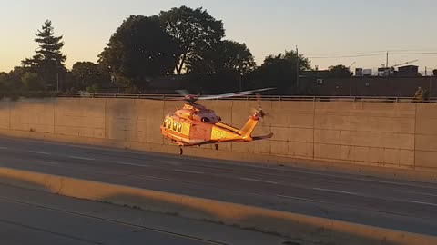 Helicopter landing in middle of the road.