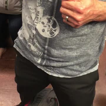 Man in grey shirt clipping his nails