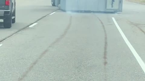 Truck Hauling a Smoking Structure