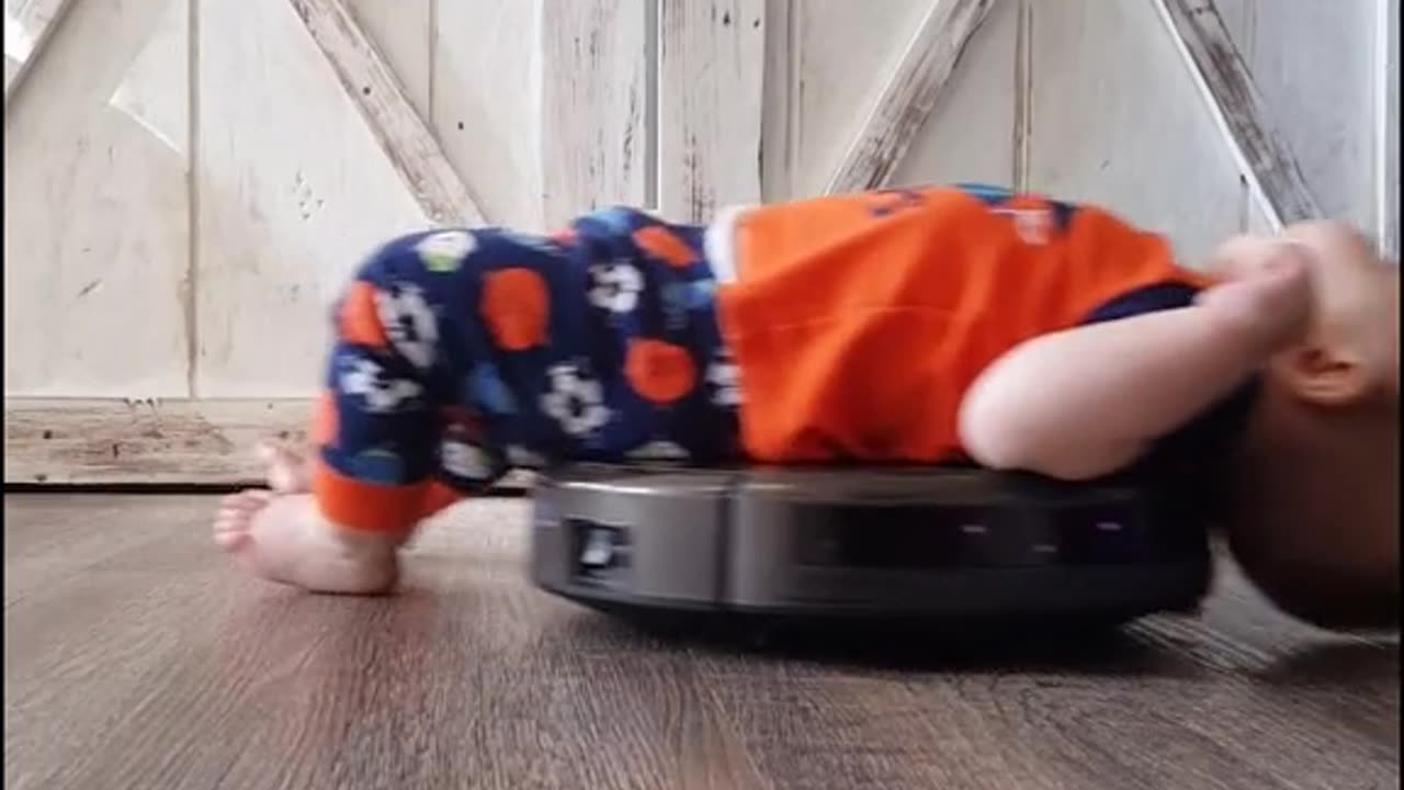 Son Relaxes On Robot Vacuum