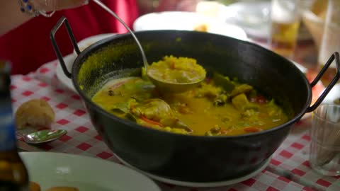 Man Serving a Meal in a Hot Pot