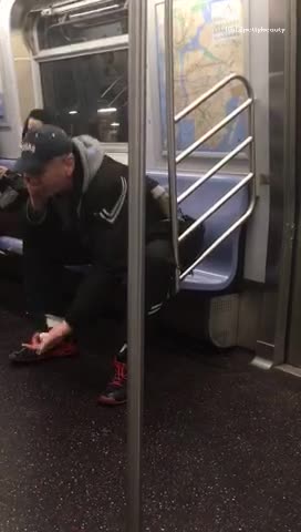 Man yelling into phone on subway train throws it at ground
