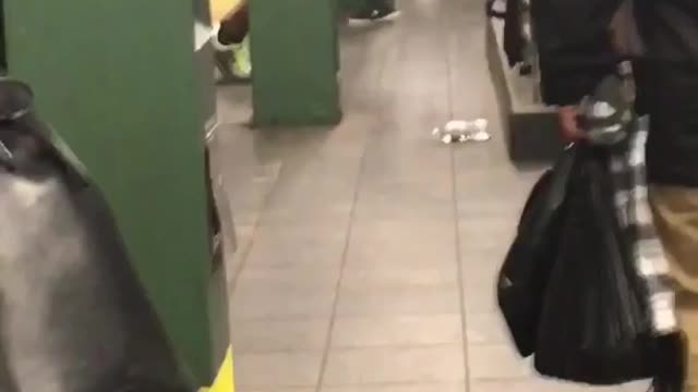 Shirtless black guy doing pushups on rail with black earphones on