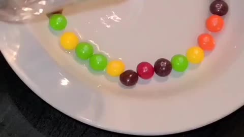 added BOILING water to a plate of SKITTLES!!.... YOU WON'T BELIEVE WHAT HAPPENED NEXT. MUST WATCH!