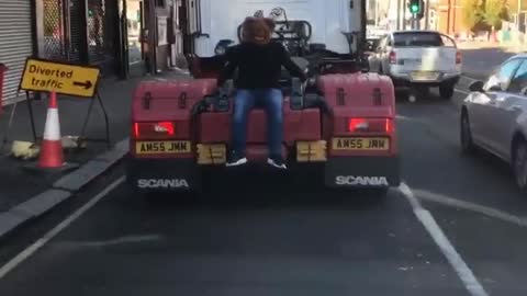 Man Wearing Bear Mask Catches a Ride