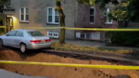 A car falls into a sinkhole amid heavy rain