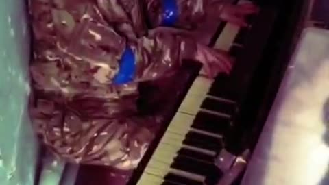 Ukrainian soldier is shooting a video on the piano