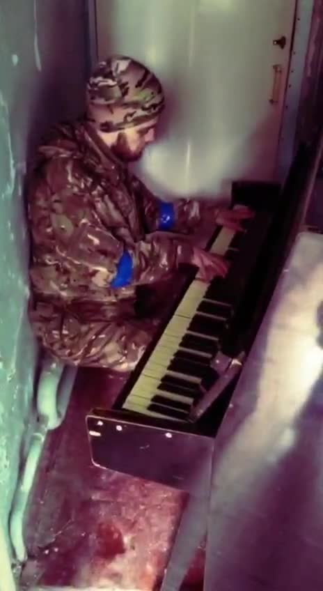 Ukrainian soldier is shooting a video on the piano