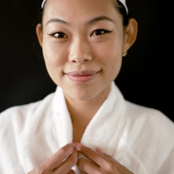 A Woman Wearing Bathrobe Smiling at Camera