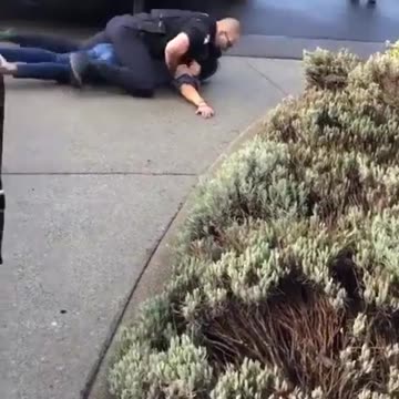 Cop chokes woman unconscious, kneels on her head.