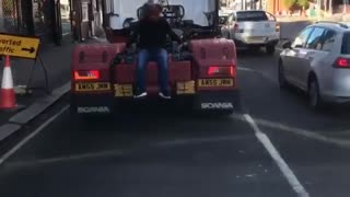 Man Wearing Bear Mask Catches a Ride