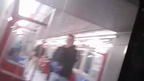 Kid rides on the back of subway train