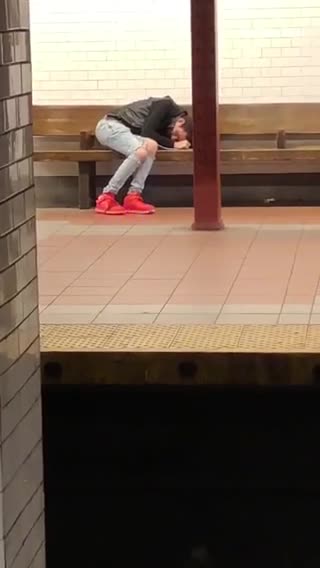Black jacket white pants glowing shies sleeping in bench subway