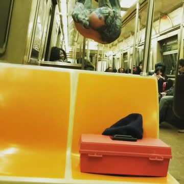 Green shirtless guy glasses hangs from subway railing