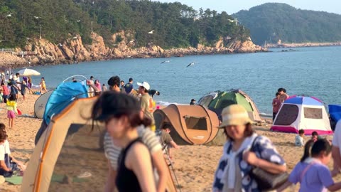 People enjoying their holidays at a beach in Incheon, South Korea, on June 18, 2023